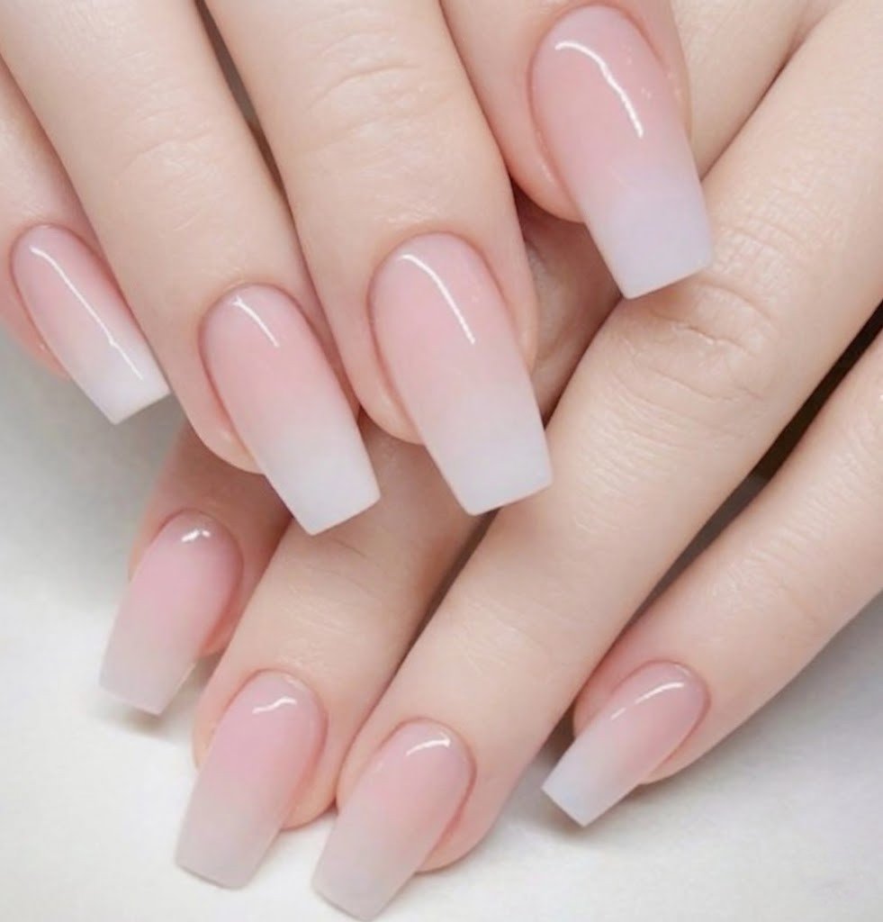 close up of finished acrylic nails in nude pink for beginners