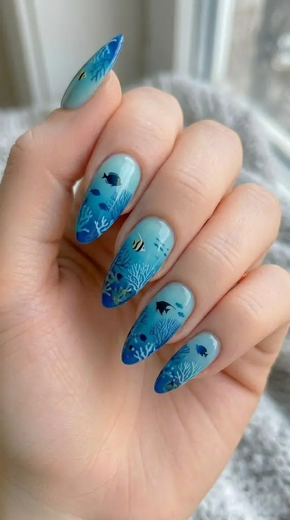 coral reef beach nail designs with angelfish and aqua to royal blue gradient on almond nails