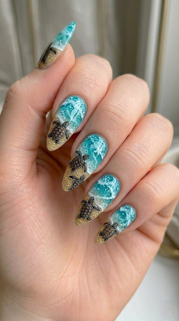 baby sea turtle beach nails with turquoise water and gold glitter sand on almond nails