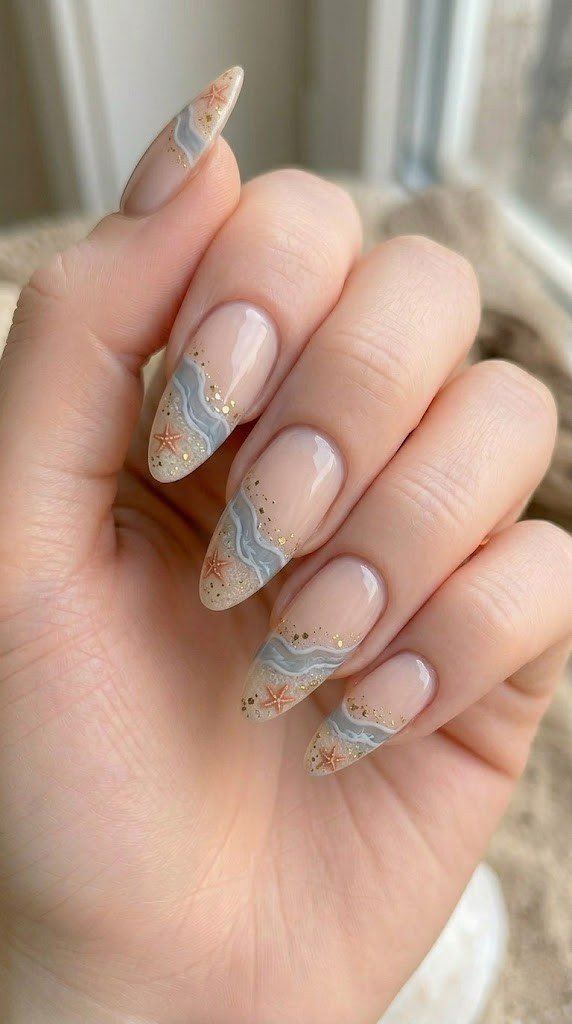 beach french tip almond nails with orange starfish and gold glitter sandy shore detail