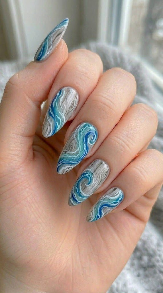 hand painted teal and royal blue ocean waves over driftwood texture base on long almond nails