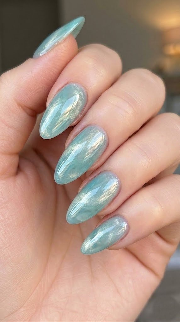 Milky mint sage almond nails with velvet silver gold diagonal shimmer cat-eye effect