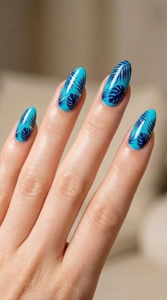 Bright turquoise almond nails with dark navy blue monstera leaves and palm frond detail