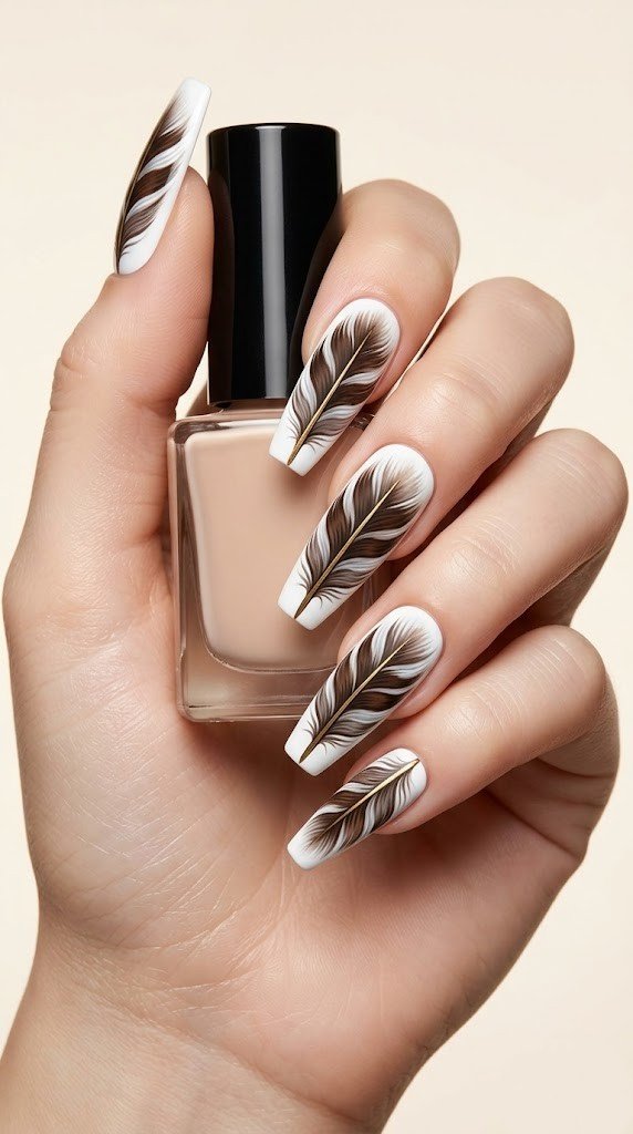 white feather nail art with gold spine on nude coffin nails elegant 4th of july design