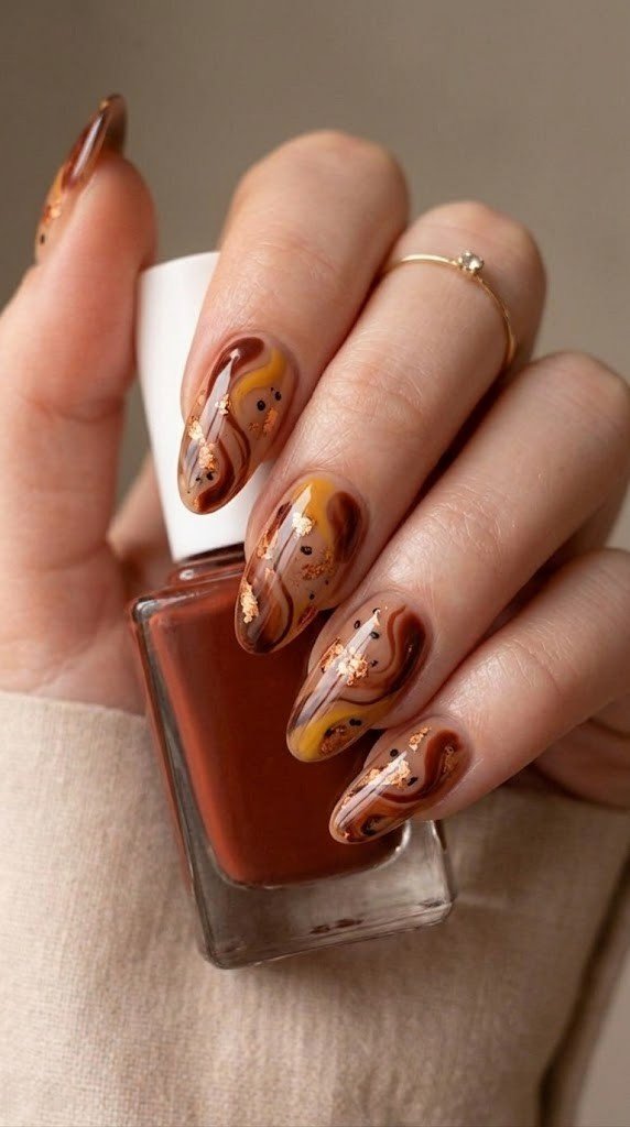 burnt sienna and curcuma yellow abstract swirl nails with copper leaf flakes and chai jelly base