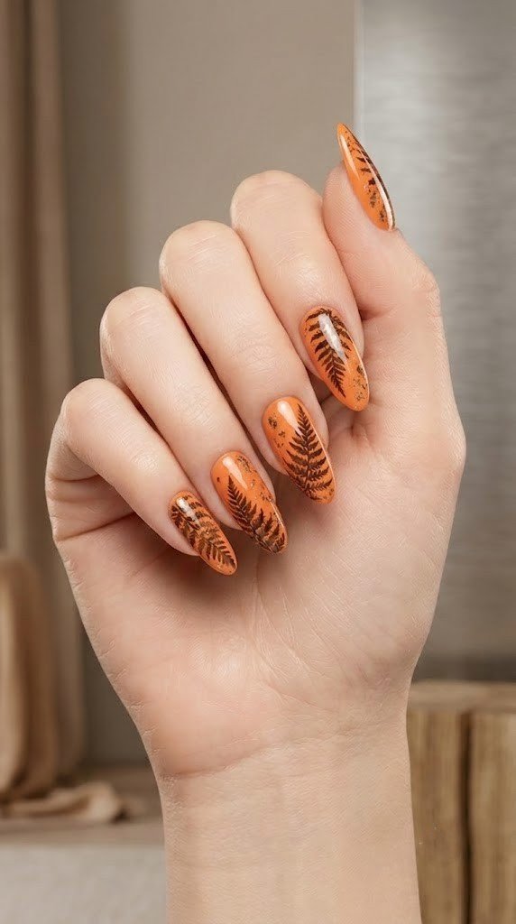 Papaya orange fall nail ideas with drying fern and bronze leaf art