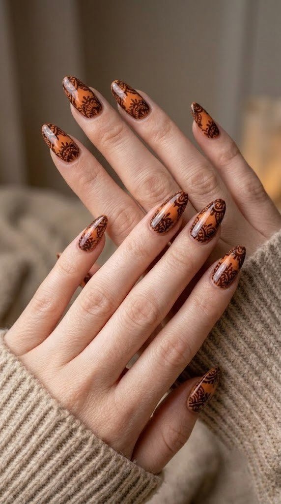 Apricot orange fall nail art ideas with espresso lace pattern on oval nails