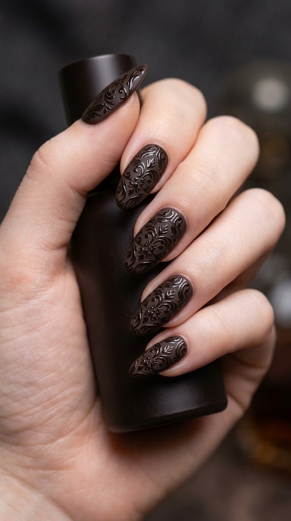 velvety matte espresso brown oval nails with high-shine tone-on-tone gothic brocade gel pattern