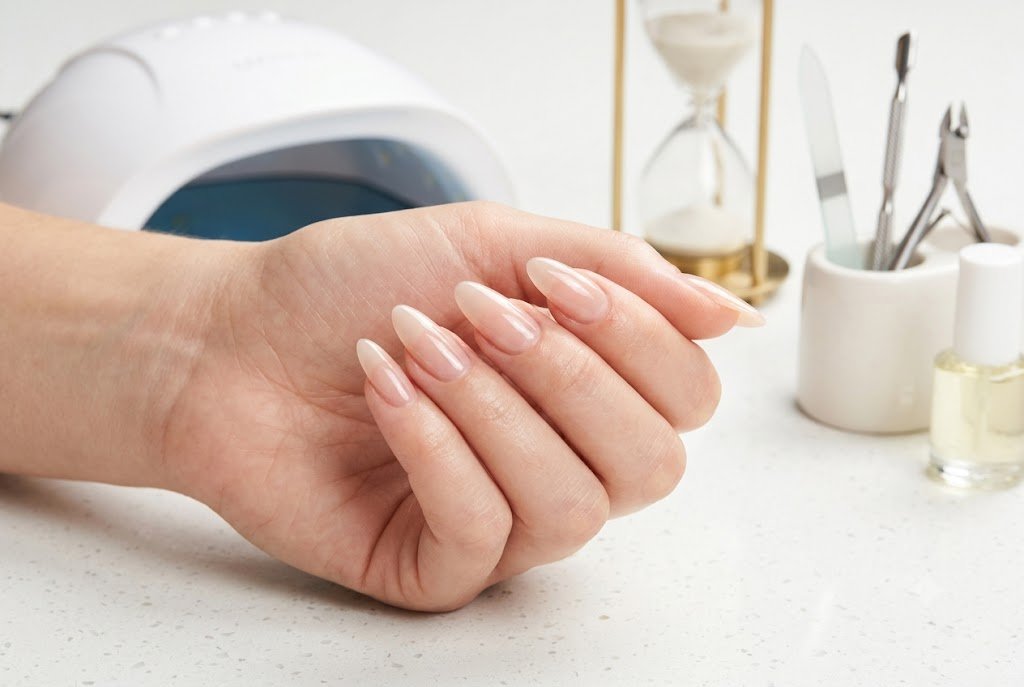 gel manicure longevity setup with UV lamp hourglass and nail care tools