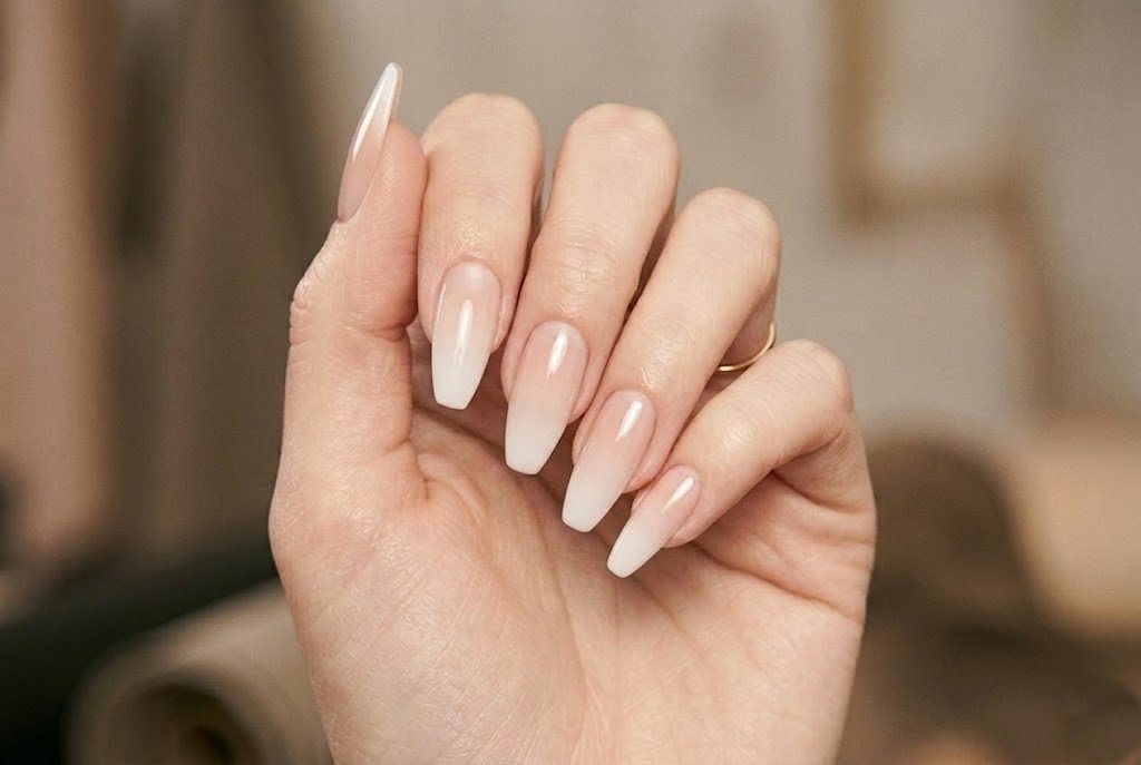Long coffin shaped french tip ombre nails with pink to white gradient finish